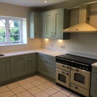 green handled kitchen by blue design kitchens